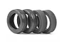 Two black rubber RC buggy front tyres with ribbed tread and two grey foam inserts arranged on a white background.