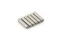 Six small cylindrical metal drive pins arranged in a row on a white background.