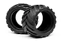 Two black rubber RC monster truck tyres with a deep chevron tread pattern, shown against a white background.