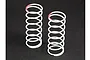 Two white coil springs for RC car shocks, each featuring a red paint mark on the top coil, standing upright on a dark surface.