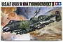 Tamiya 1/48 scale A-10A Thunderbolt II plastic model kit box art showing a painted illustration of the aircraft in flight over a desert battlefield.