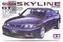 Tamiya 1/24 scale Nissan Skyline GT-R V-Spec plastic model kit box art featuring a purple R33 GT-R.