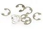 A small pile of silver-coloured metal E-clips for RC car maintenance.