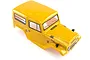 A mustard yellow pre-painted RC crawler body shell for an HSP 1/10 scale Rock Cruiser truck, viewed from a high angle against a white background.