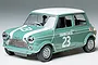 A 1/24 scale Tamiya Morris Mini Cooper model car, painted green with a white roof and racing number 23 on the hood and doors.