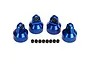 Four blue anodized aluminium shock caps with small black spacers arranged on a white background.