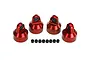 Four red anodized aluminium shock caps and eight small black spacers arranged on a white background.