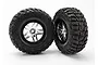 Two Traxxas 2.2/3.0 inch Kumho Road Venture MT tyres pre-mounted on satin chrome and black wheels against a white background.
