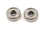 Two small metal shielded ball bearings side by side on a white background.