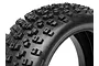 Close-up of a black rubber RC buggy tyre with a blocky tread pattern against a white background.