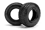 Two black HPI Racing Blitz ATTK short course RC tyres with aggressive tread patterns, shown from a side-angle view on a white background.