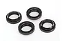 Four black anodized aluminium shock adjusting nuts with internal threads and O-rings, arranged on a white background.