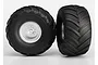Two Traxxas Terra Groove RC monster truck tires mounted on satin chrome wheels, shown from front and side angles against a white background.