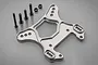 A silver aluminium front shock tower for an RC car with four black screws and two nuts on a grey background.