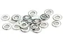 A pile of small, silver-coloured metal washers scattered on a white background.