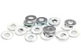 A pile of small, thin, silver-coloured metal washers scattered on a white background.