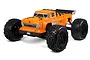 Studio shot of an ARRMA Outcast 6S BLX 1/8 scale RC stunt truck in orange with black wheels and a rear wing on a white background.