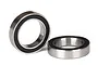 Two Traxxas rubber-shielded ball bearings shown against a white background, one standing upright and one lying flat.