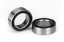 Two small metal ball bearings with black rubber seals sitting on a white background.