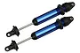 Two assembled blue aluminium GTX shock absorbers for Traxxas X-Maxx, shown without springs against a white background.