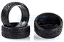 A set of four black RC drift tyres with a directional tread pattern, arranged on a white background.