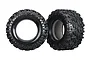 Two black Traxxas X-Maxx 8S all-terrain RC monster truck tyres shown from side and front angles.