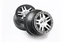 Two Traxxas 2.2/3.0 inch split-spoke RC rims with black outer rings and satin chrome centers, shown against a white background.