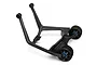 A black Traxxas X-Maxx wheelie bar assembly featuring two wheels and a sturdy plastic frame on a white background.