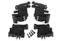 Traxxas X-Maxx battery mount set including four black plastic battery hold-down components and four small metal screws on a white background.