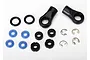 A collection of small RC shock rebuild parts including black plastic rod ends, O-rings, blue seals, spacers, and metal E-clips on a white background.