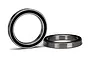 Two rubber-shielded ball bearings for RC vehicles, one standing upright and one lying flat on a white surface.