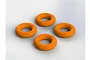 Four bright orange rubber O-rings arranged in a diamond pattern on a plain white background.