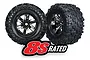 Two Traxxas X-Maxx 8S monster truck wheels with black chrome rims and aggressive all-terrain rubber tires against a white background.