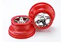 Two Traxxas RC short course wheels with red plastic outer rims and chrome-plated six-spoke centers against a white background.