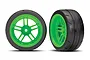 Two Traxxas 1.9 inch Response slick tires pre-glued onto bright green split-spoke RC wheels against a white background.