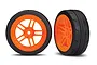 Two Traxxas 1.9 inch Response slick tyres mounted on bright orange split-spoke wheels, shown from front and angled perspectives.