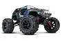 Traxxas 1/16 Summit RC monster truck with blue, red, and yellow graphic body, black wheels, and LED roof lights on a white background.