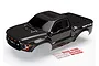 A black Traxxas 2017 Ford Raptor RC truck body shell with a decal sheet on a white background.