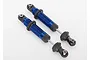 Two blue anodized aluminium Traxxas GTS shock absorbers for RC cars, shown against a plain white background.