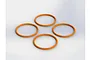 Four orange rubber O-rings arranged in a diamond pattern against a plain white background.