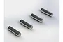 Four identical silver metal drive pins arranged in a diagonal line on a white background.
