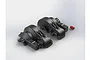 Two black plastic ARRMA centre gearbox case halves and a small red plastic component on a white background.