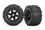 Two Traxxas 3.8 inch Talon EXT monster truck tires pre-mounted on black six-spoke wheels against a white background.