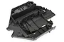 A black plastic main chassis component for a Traxxas Unlimited Desert Racer RC vehicle, shown from a high-angle studio view.