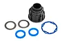 Traxxas UDR differential case set including a black plastic housing, two metal shims, two blue rubber seals, and a blue rubber gasket.