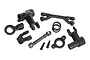 Traxxas UDR steering bell crank set components including black plastic bell cranks, servo saver spring, linkage, and mounting hardware.