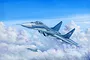 An artistic illustration of a Russian MiG-29A Fulcrum fighter jet flying through a cloudy blue sky, with a second jet visible in the distance.