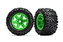 Two Traxxas 3.8 inch Talon EXT RC monster truck tires pre-glued onto bright green six-spoke plastic wheels against a white background.