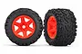 Two Traxxas 3.8 inch Talon EXT RC monster truck tyres pre-glued onto bright orange six-spoke plastic rims against a white background.
