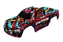 A pre-painted Traxxas Stampede RC truck body shell featuring a vibrant Hawaiian-style abstract pattern in blue, red, yellow, and black.